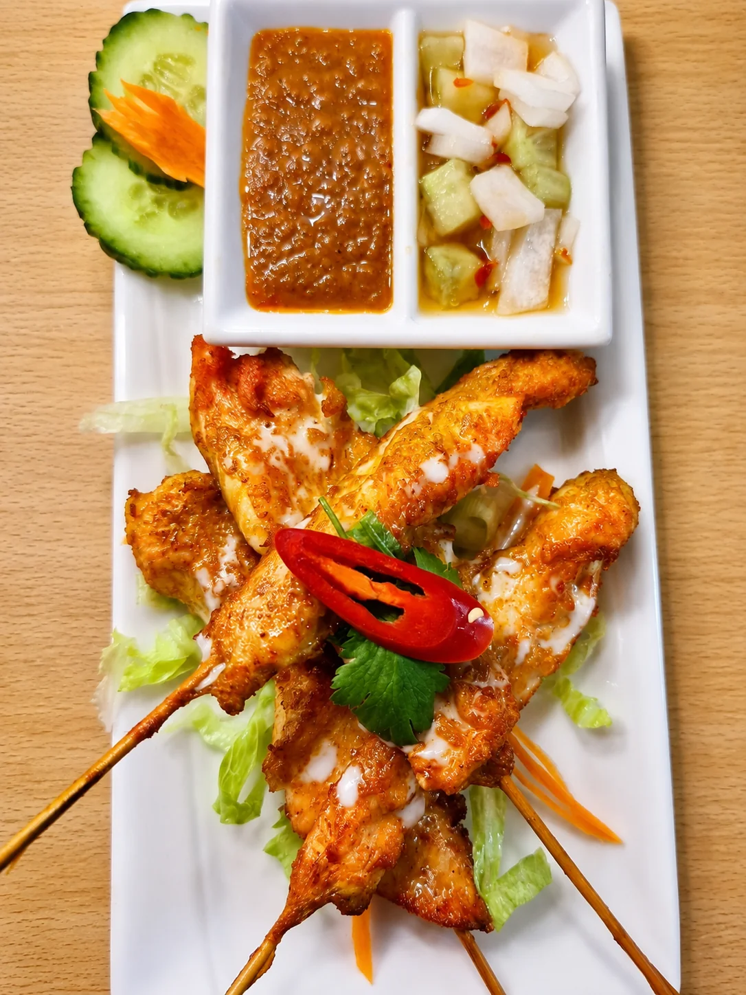 Chicken satay skewers with cucumber relish and peanut sauce
