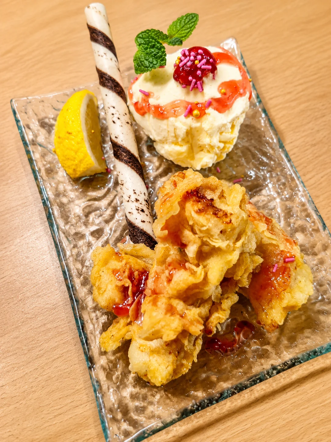 Crisp fried dessert served with ice cream, lemon, mint and a wafer roll